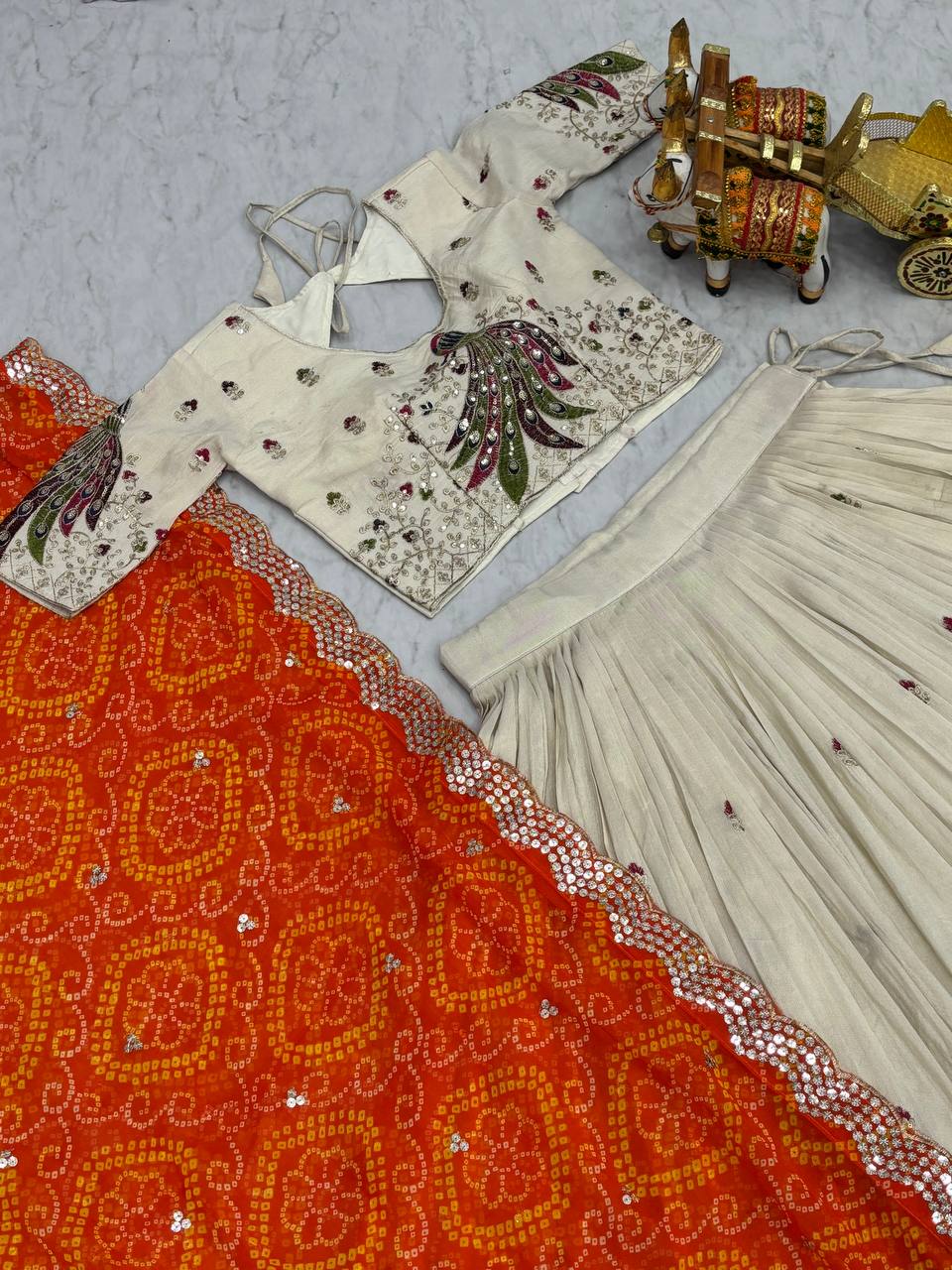 Amla off-white tissue silk lehenga choli with sequins thread work and orange Bandhej dupatta