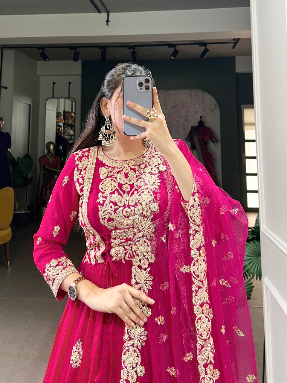 Anwitha Pink Embroidered Silk Anarkali Gown Set, crafted from luxurious Vichitra Silk with intricate sequins and thread embroidery accented by delicate lace details. This fully stitched Anarkali gown features a 3-meter flair and a soft cotton lining for comfort. Paired with a graceful net dupatta adorned with sequins embroidery and a lace border, this elegant ensemble is perfect for weddings, festive occasions, and grand celebrations