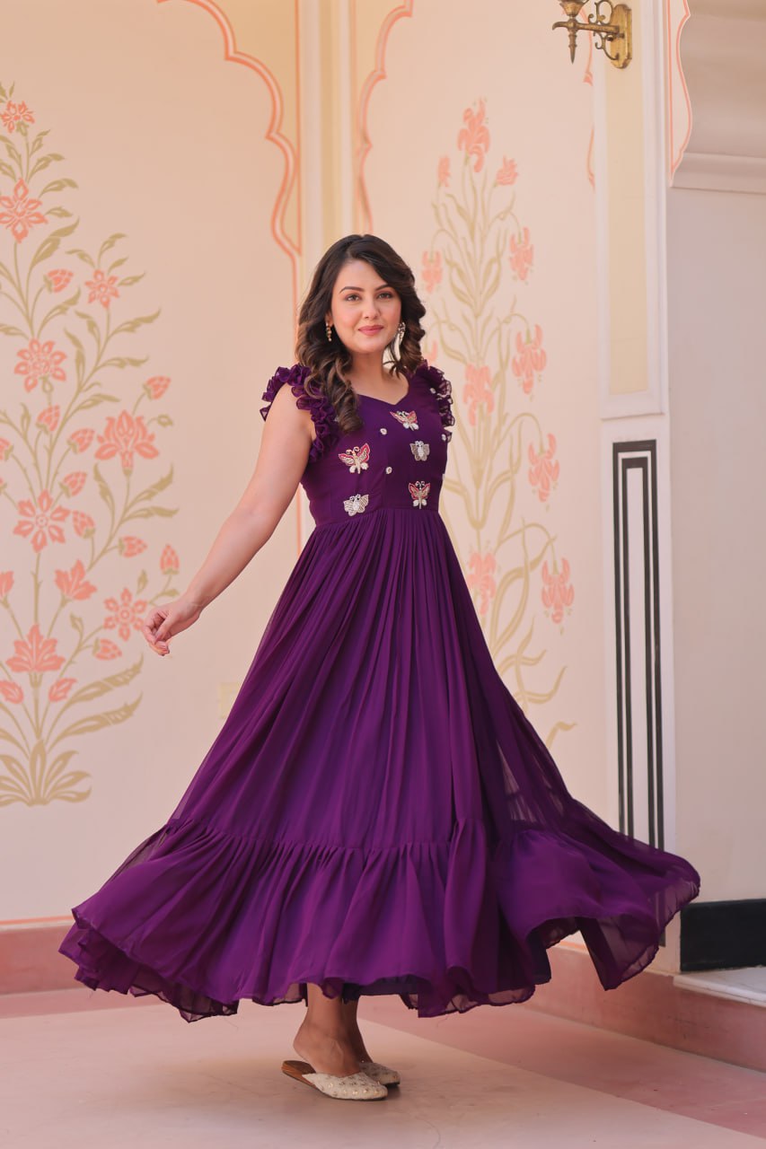 Lavi 7-meter flared designer gown in faux blooming fabric with sequin & bead embroidery, V-neck & frill shoulders – perfect for weddings & parties.