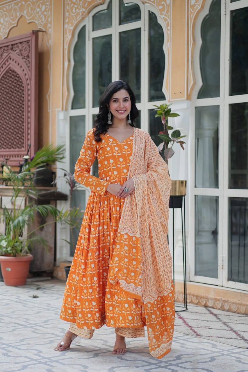 The Ridhvini Orange Pure Cotton Printed Anarkali Set is a stylish and breathable cotton Anarkali suit for women, perfect for daily wear, office wear, and festive occasions. Made from premium pure cotton, this readymade Anarkali kurta set offers comfort and elegance with a flowing silhouette, fancy V-neck, and full sleeves. Paired with straight cotton pants and a matching dupatta, this ethnic cotton suit is ideal for summer fashion. Whether you're looking for a lightweight festive outfit or a printed Anarkal