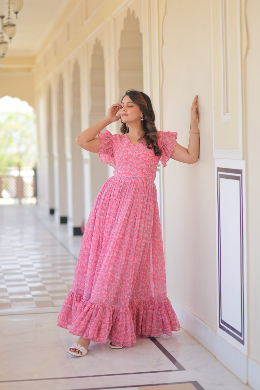 Printed pink georgette gown for women with 7-meter flair, bell sleeves & V-neck—lightweight ethnic dress for Haldi, Mehendi, Navratri & festive functions.