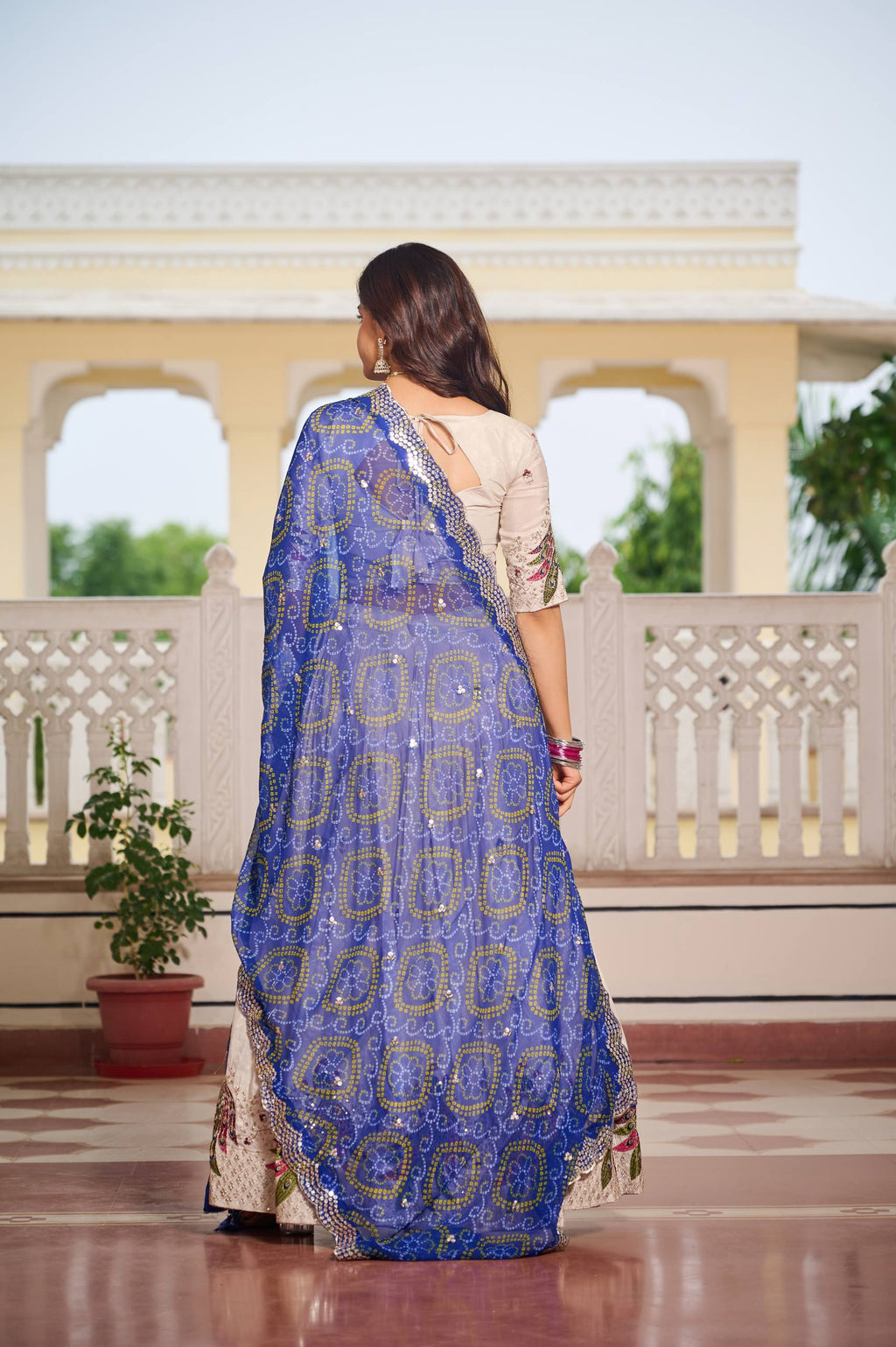 Amla off-white tissue silk lehenga choli with sequins thread work and blue Bandhej dupatta