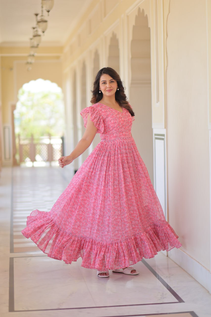 Printed pink georgette gown for women with 7-meter flair, bell sleeves & V-neck—lightweight ethnic dress for Haldi, Mehendi, Navratri & festive functions.