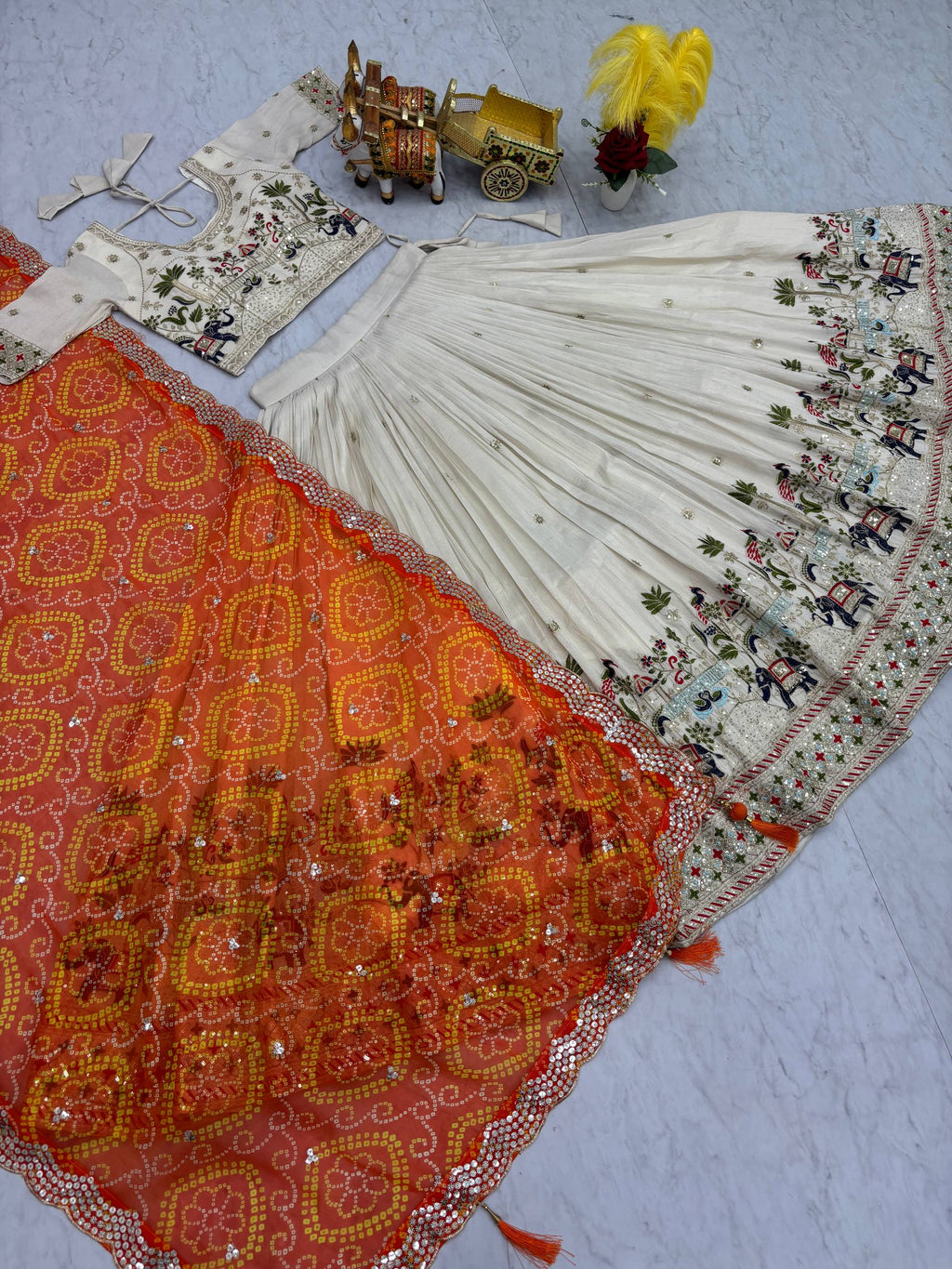 Off-white silk sequins thread embroidery lehenga choli with orange Bandhej dupatta