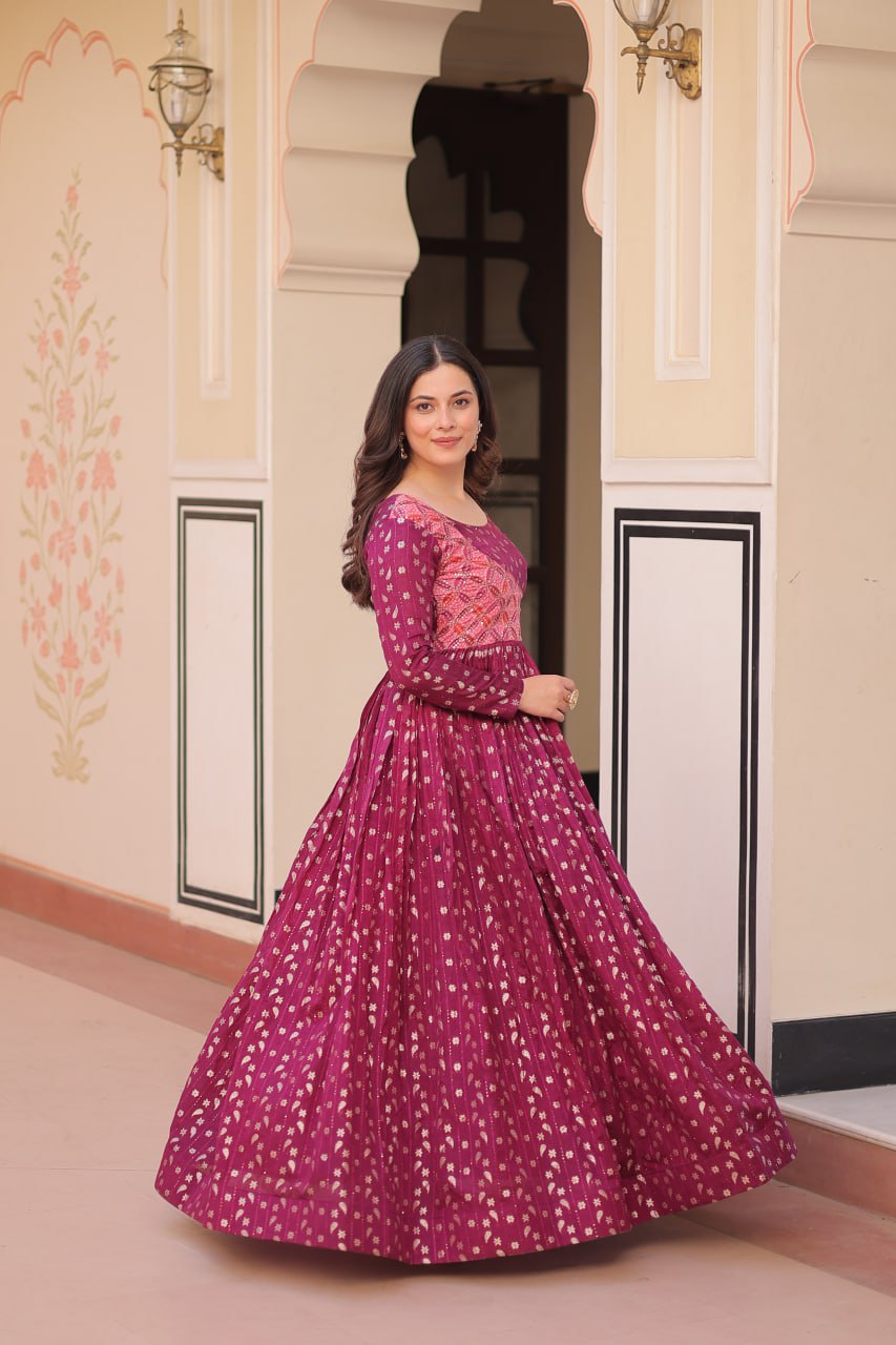 Vani Choli Printed Wine Color Gown with staple jacquard fabric, full sleeves, cotton lining, and 3-meter flare – perfect ethnic party wear gown for wedding functions, festive nights, and modern Indian women.