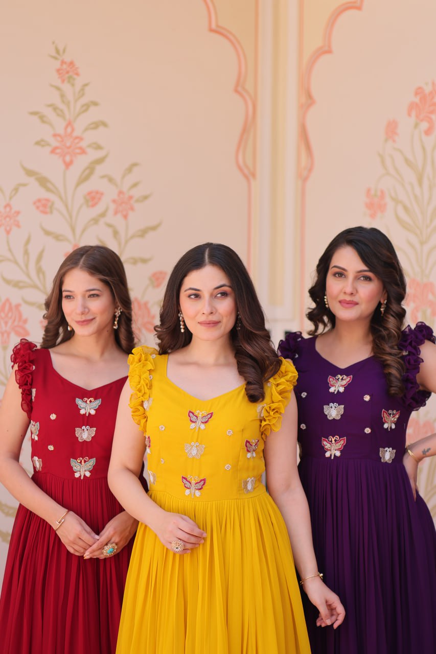 Lavi 7-meter flared designer gown in faux blooming fabric with sequin & bead embroidery, V-neck & frill shoulders – perfect for weddings & parties.