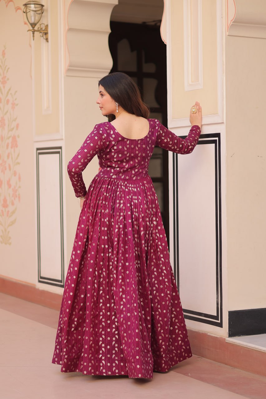 Vani Choli Printed Wine Color Gown with staple jacquard fabric, full sleeves, cotton lining, and 3-meter flare – perfect ethnic party wear gown for wedding functions, festive nights, and modern Indian women.