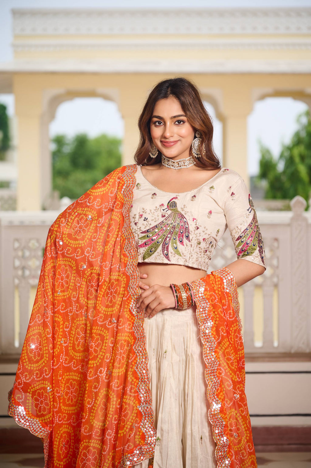 Amla off-white tissue silk lehenga choli with sequins thread work and orange Bandhej dupatta