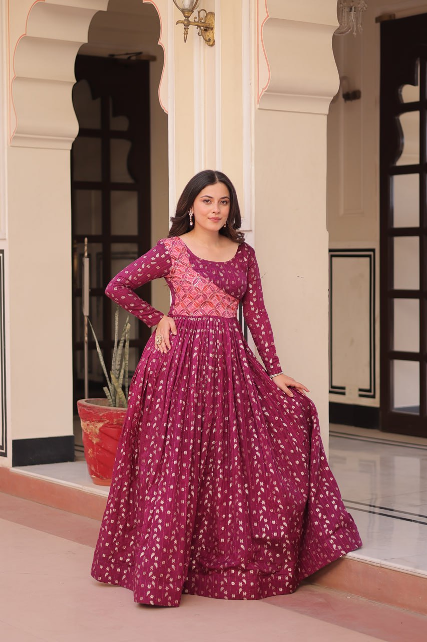 Vani Choli Printed Wine Color Gown with staple jacquard fabric, full sleeves, cotton lining, and 3-meter flare – perfect ethnic party wear gown for wedding functions, festive nights, and modern Indian women.