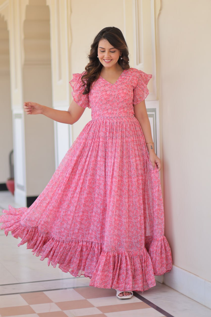 Printed pink georgette gown for women with 7-meter flair, bell sleeves & V-neck—lightweight ethnic dress for Haldi, Mehendi, Navratri & festive functions.