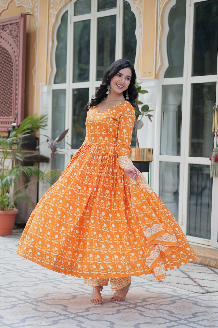 The Ridhvini Orange Pure Cotton Printed Anarkali Set is a stylish and breathable cotton Anarkali suit for women, perfect for daily wear, office wear, and festive occasions. Made from premium pure cotton, this readymade Anarkali kurta set offers comfort and elegance with a flowing silhouette, fancy V-neck, and full sleeves. Paired with straight cotton pants and a matching dupatta, this ethnic cotton suit is ideal for summer fashion. Whether you're looking for a lightweight festive outfit or a printed Anarkal