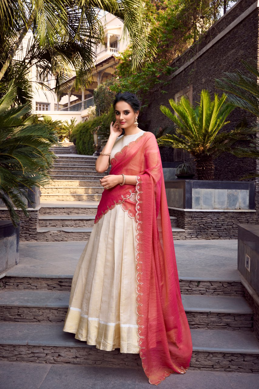 Off-white Jacquard Chex lehenga choli with intricate zari weaving, 4-meter flair, paired with shimmer dupatta featuring sequin and thread embroidery – perfect for weddings and festive celebrations.