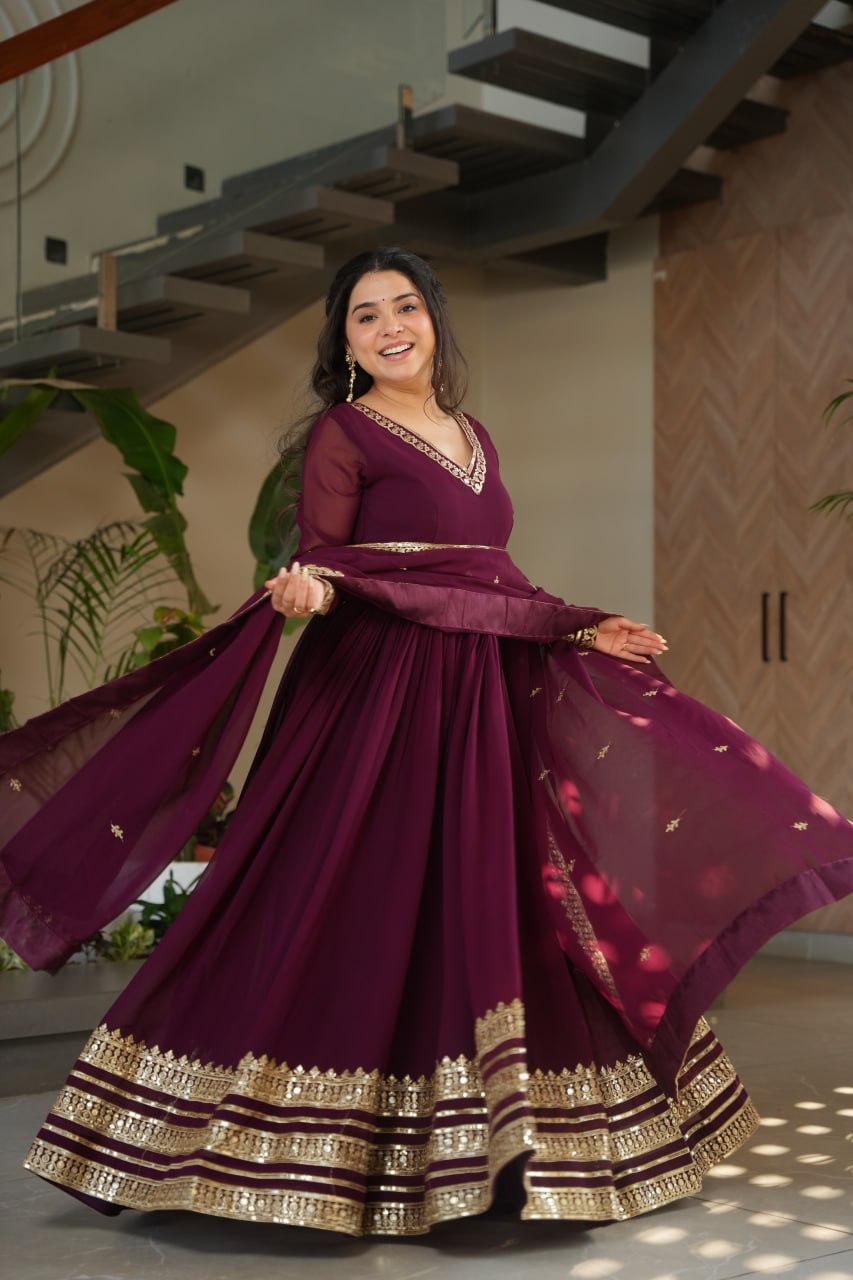 Sampriti Wine Embroidered Gown Set – wine color gown with dupatta, zari sequin ethnic gown, faux blooming fabric gown for women, V-neck partywear gown, wedding guest long gown, Indian embroidered gown dress, full sleeve flair gown, bridal festive ethnic outfit, designer wine Anarkali gown, fully stitched traditional gown.