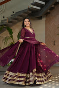 Sampriti Wine Embroidered Gown Set – wine color gown with dupatta, zari sequin ethnic gown, faux blooming fabric gown for women, V-neck partywear gown, wedding guest long gown, Indian embroidered gown dress, full sleeve flair gown, bridal festive ethnic outfit, designer wine Anarkali gown, fully stitched traditional gown.