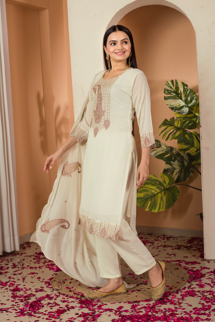 Khyati Off-White Embroidered Kurti Set crafted from premium Fox Georgette, featuring intricate heavy thread and sequins embroidery. This elegant ensemble includes a fully stitched kurti with a butter crepe lining, a matching stitched bottom, and an embroidered Fox Georgette dupatta. Designed for festive gatherings and special occasions, it beautifully blends tradition with modern sophistication