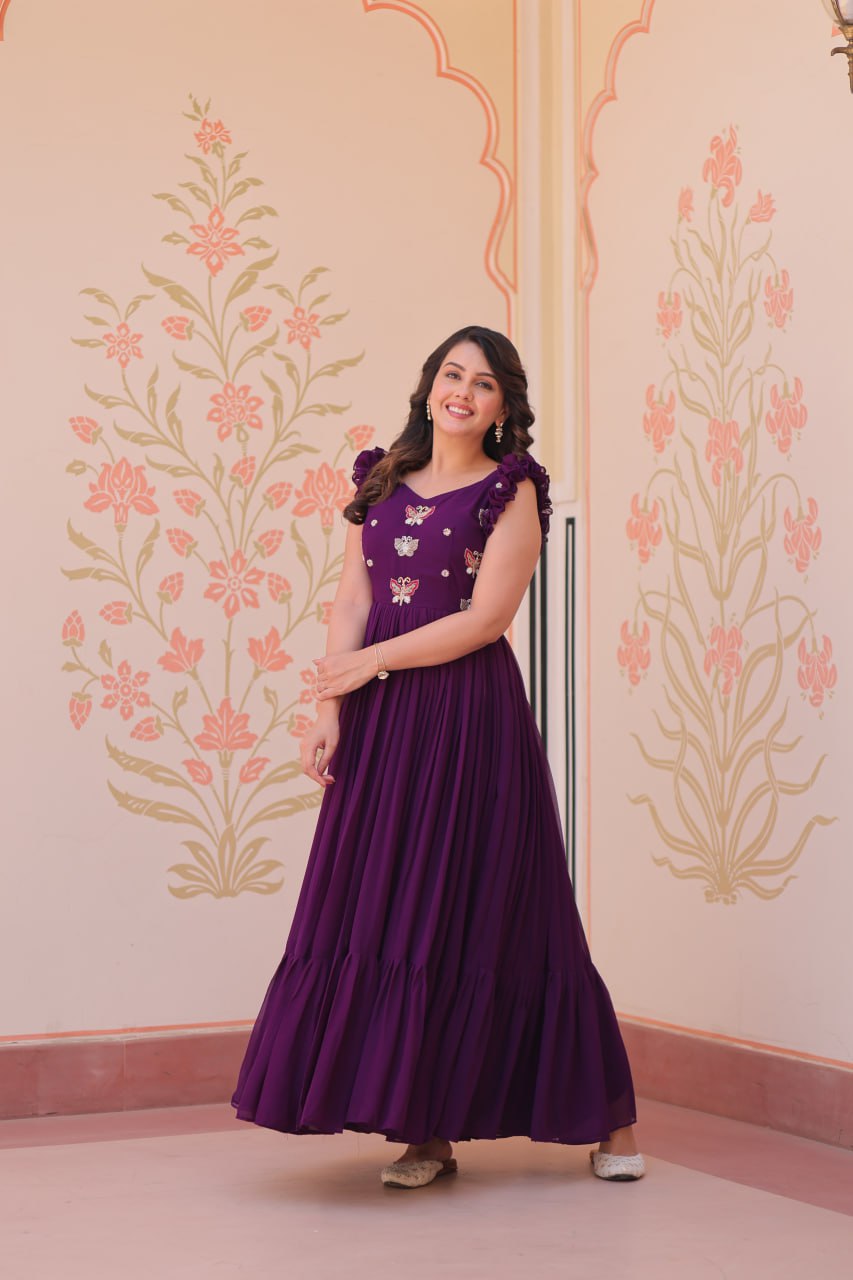 Lavi 7-meter flared designer gown in faux blooming fabric with sequin & bead embroidery, V-neck & frill shoulders – perfect for weddings & parties.