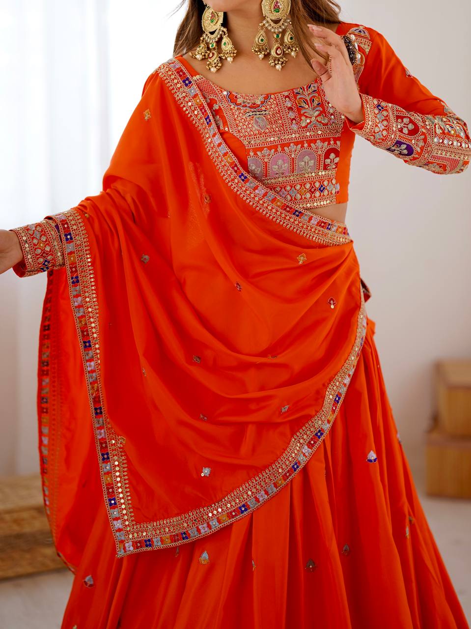 Kavyani Orange Crepe Silk Lehenga with dori-thread-sequin work, 3m flair & dupatta – semi-stitched festive wear for weddings.