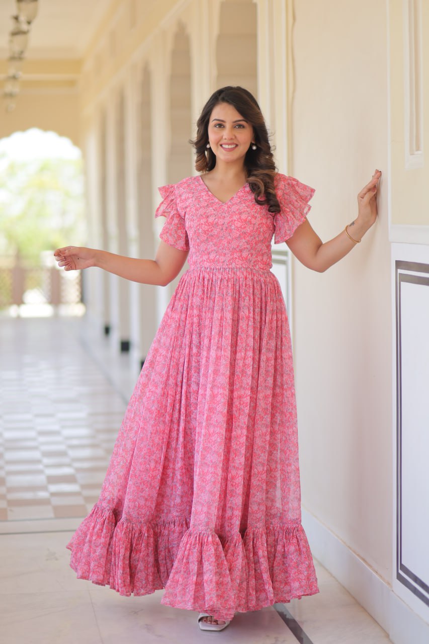 Printed pink georgette gown for women with 7-meter flair, bell sleeves & V-neck—lightweight ethnic dress for Haldi, Mehendi, Navratri & festive functions.