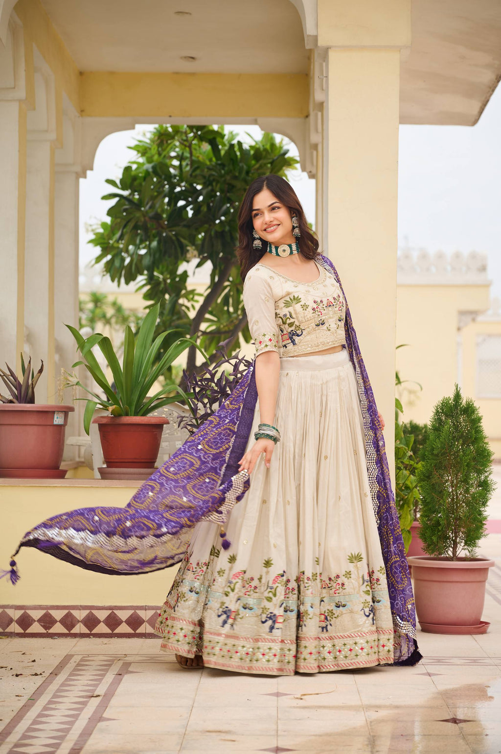 Off-white silk sequins thread embroidery lehenga choli with purple Bandhej dupatta