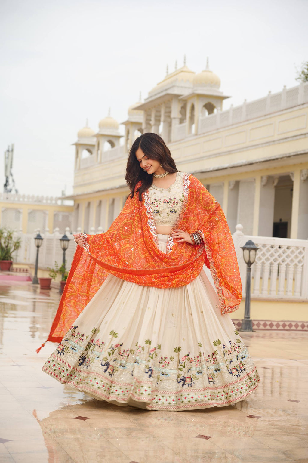 Off-white silk sequins thread embroidery lehenga choli with orange Bandhej dupatta
