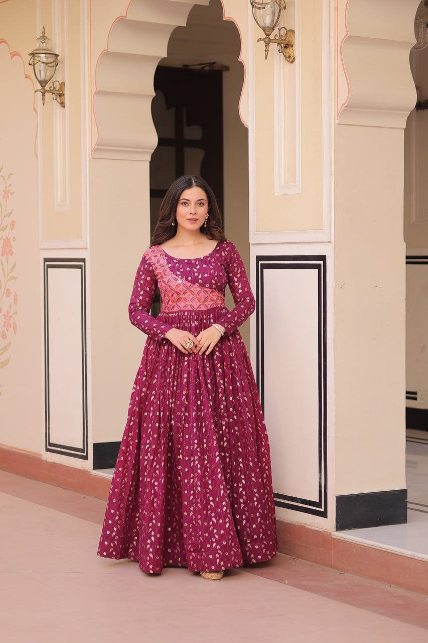 Vani Choli Printed Wine Color Gown with staple jacquard fabric, full sleeves, cotton lining, and 3-meter flare – perfect ethnic party wear gown for wedding functions, festive nights, and modern Indian women.