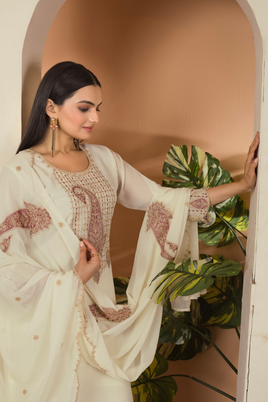 Khyati Off-White Embroidered Kurti Set crafted from premium Fox Georgette, featuring intricate heavy thread and sequins embroidery. This elegant ensemble includes a fully stitched kurti with a butter crepe lining, a matching stitched bottom, and an embroidered Fox Georgette dupatta. Designed for festive gatherings and special occasions, it beautifully blends tradition with modern sophistication