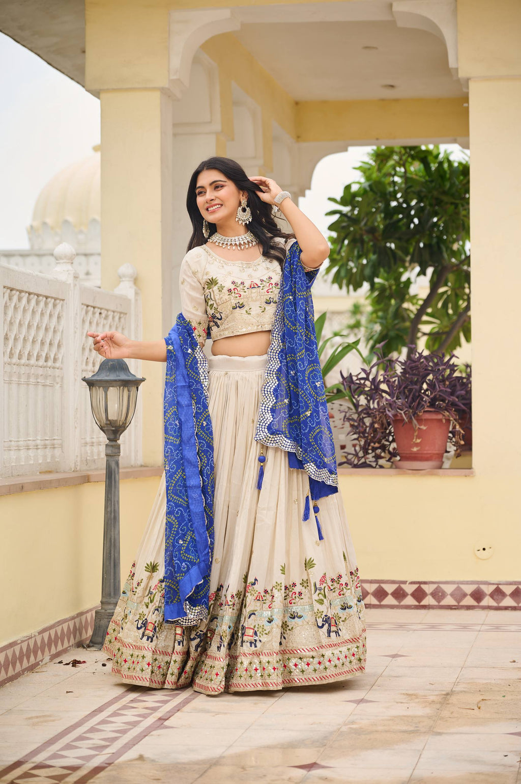 Off-white silk sequins thread embroidery lehenga choli with blue Bandhej dupatta