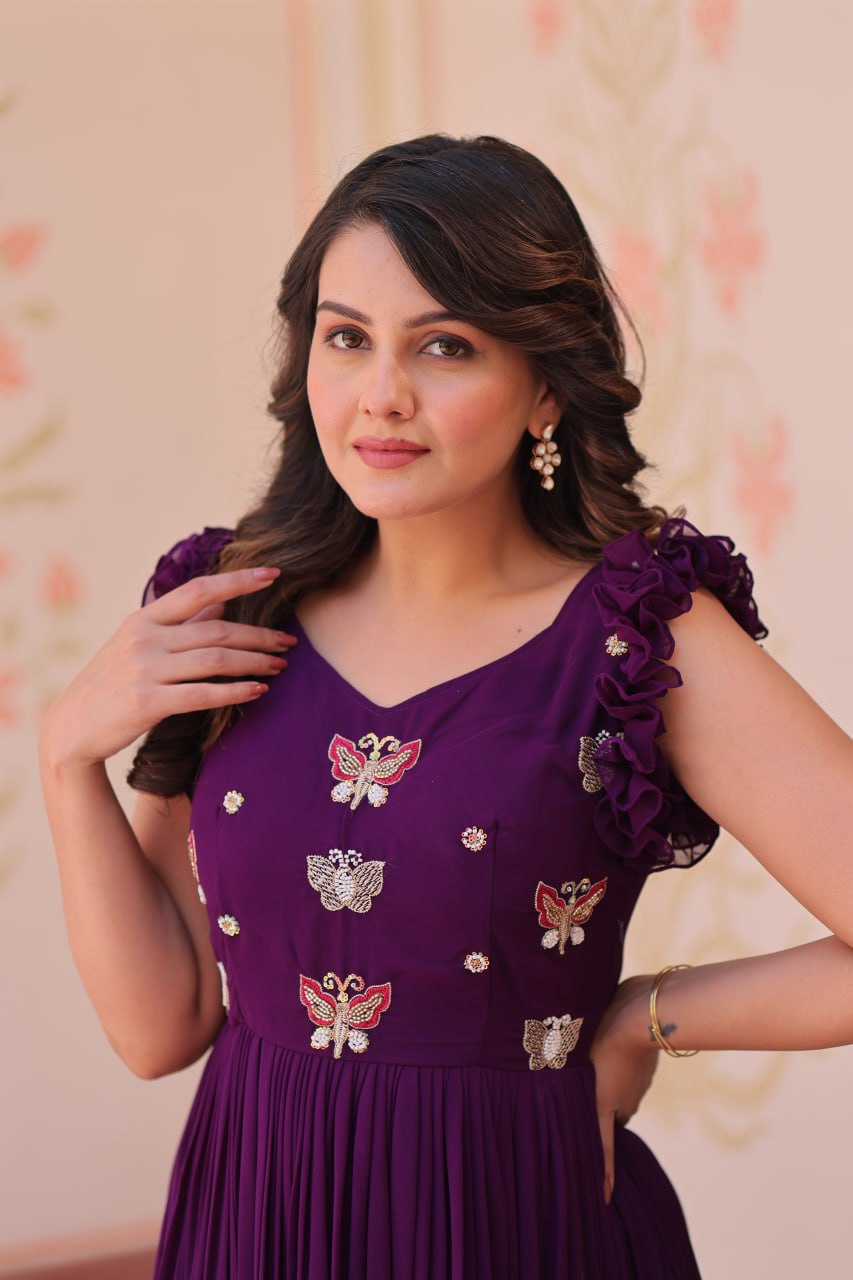 Lavi 7-meter flared designer gown in faux blooming fabric with sequin & bead embroidery, V-neck & frill shoulders – perfect for weddings & parties.