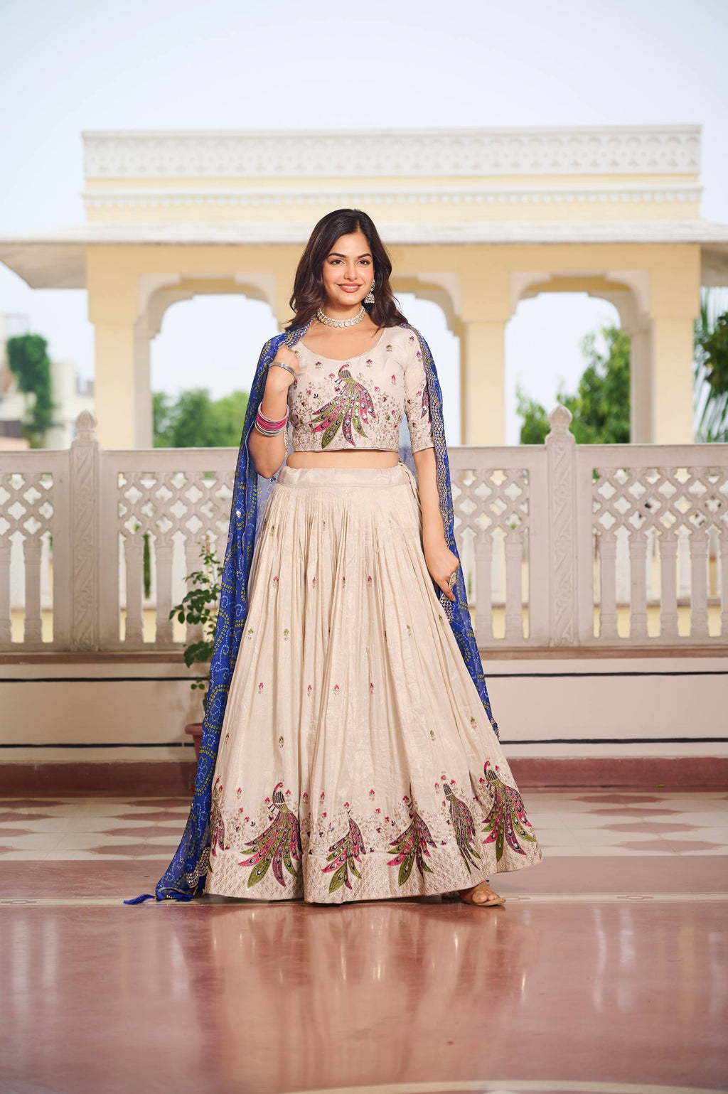 Amla off-white tissue silk lehenga choli with sequins thread work and blue Bandhej dupatta