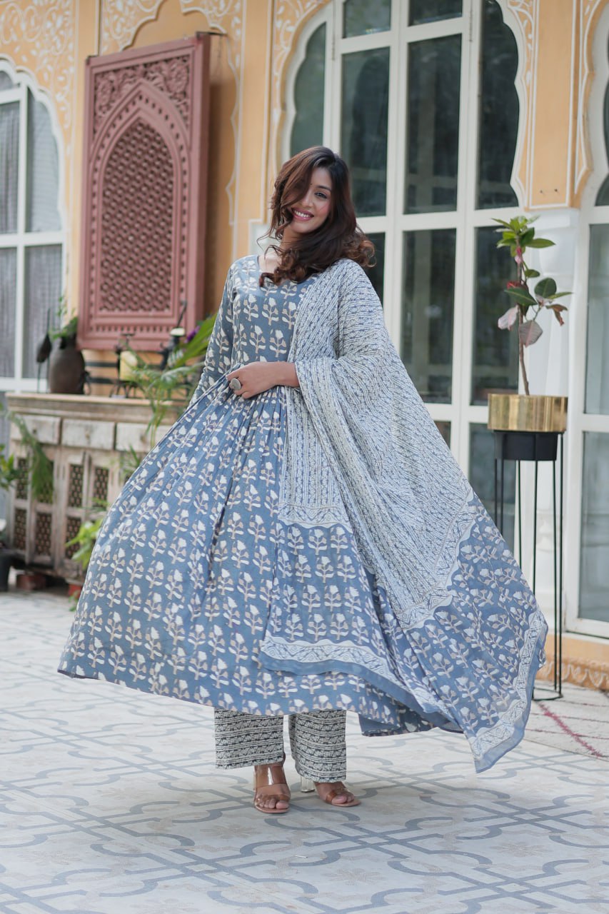 The Ridhvini Orange Cotton Anarkali Set is a stylish and comfortable ethnic wear choice for women, crafted from premium pure cotton. This readymade Anarkali suit set features a long Anarkali kurti with a fancy V-neck and full sleeves, paired with breathable cotton straight pants and a matching cotton dupatta. Ideal for daily wear, office wear, and festive occasions, this lightweight Anarkali cotton kurta set is designed for effortless elegance. Whether you're looking for a casual cotton suit, summer ethnic 