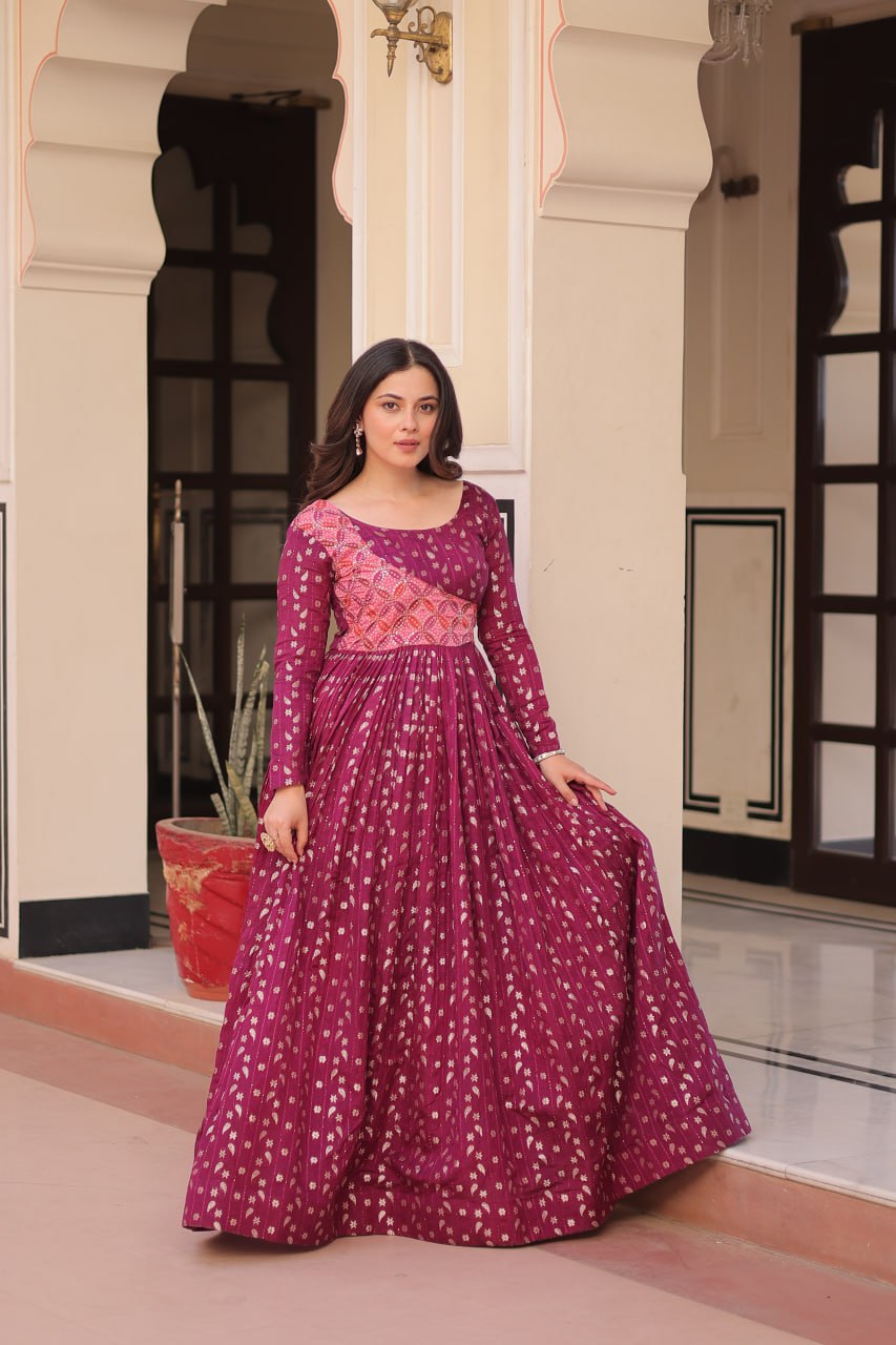 Vani Choli Printed Wine Color Gown with staple jacquard fabric, full sleeves, cotton lining, and 3-meter flare – perfect ethnic party wear gown for wedding functions, festive nights, and modern Indian women.