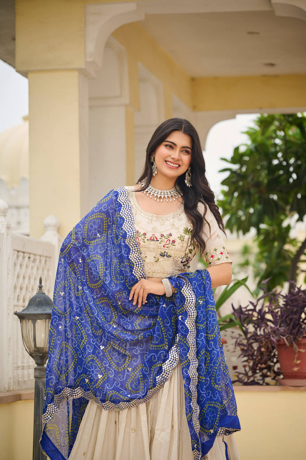 Off-white silk sequins thread embroidery lehenga choli with blue Bandhej dupatta