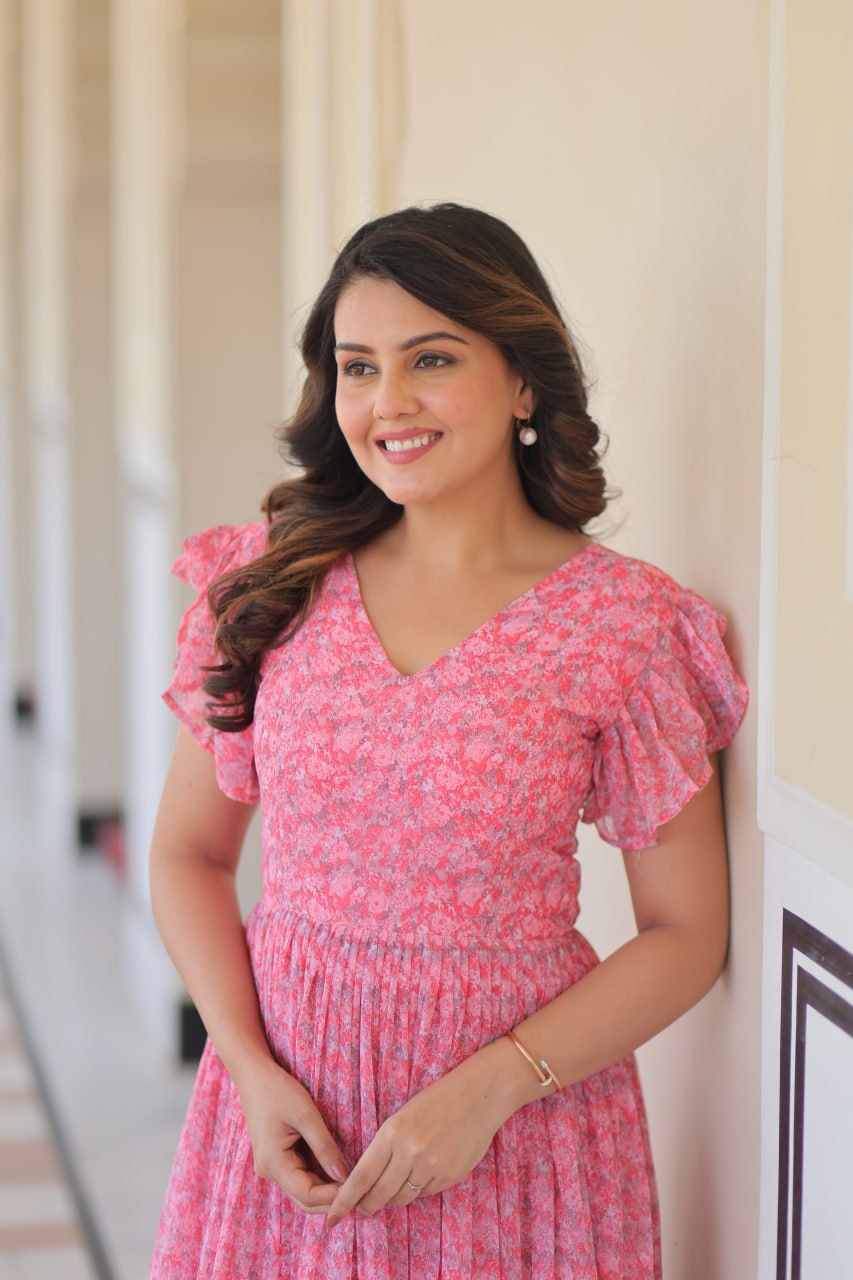 Printed pink georgette gown for women with 7-meter flair, bell sleeves & V-neck—lightweight ethnic dress for Haldi, Mehendi, Navratri & festive functions.