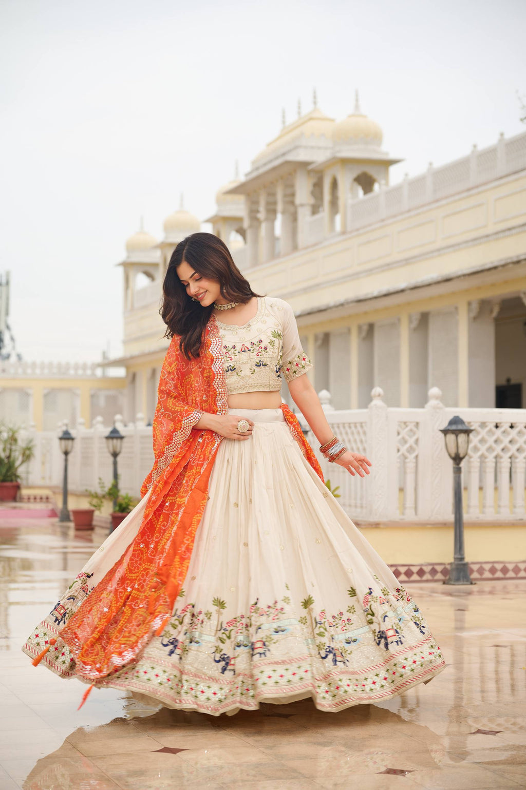 Off-white silk sequins thread embroidery lehenga choli with orange Bandhej dupatta