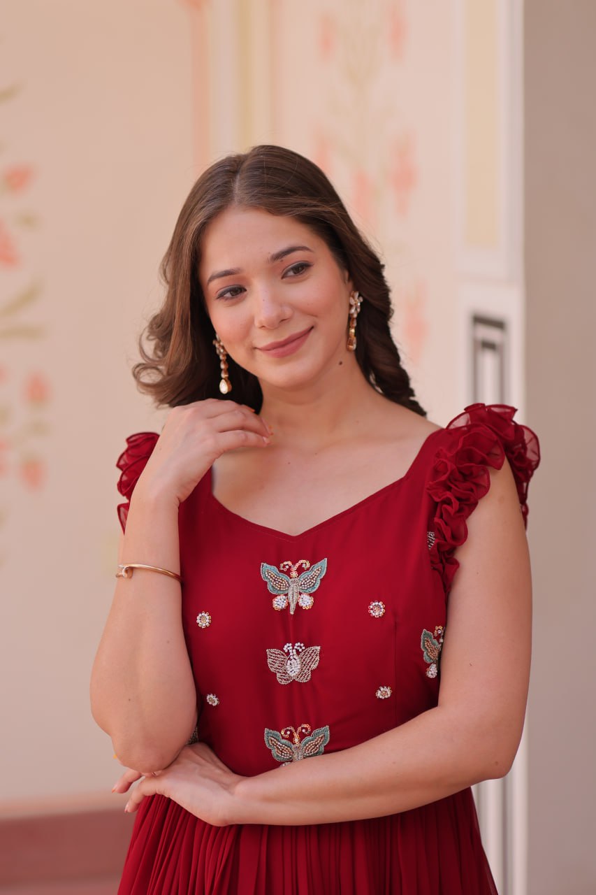 Lavi 7-meter flared designer gown in faux blooming fabric with sequin & bead embroidery, V-neck & frill shoulders – perfect for weddings & parties.