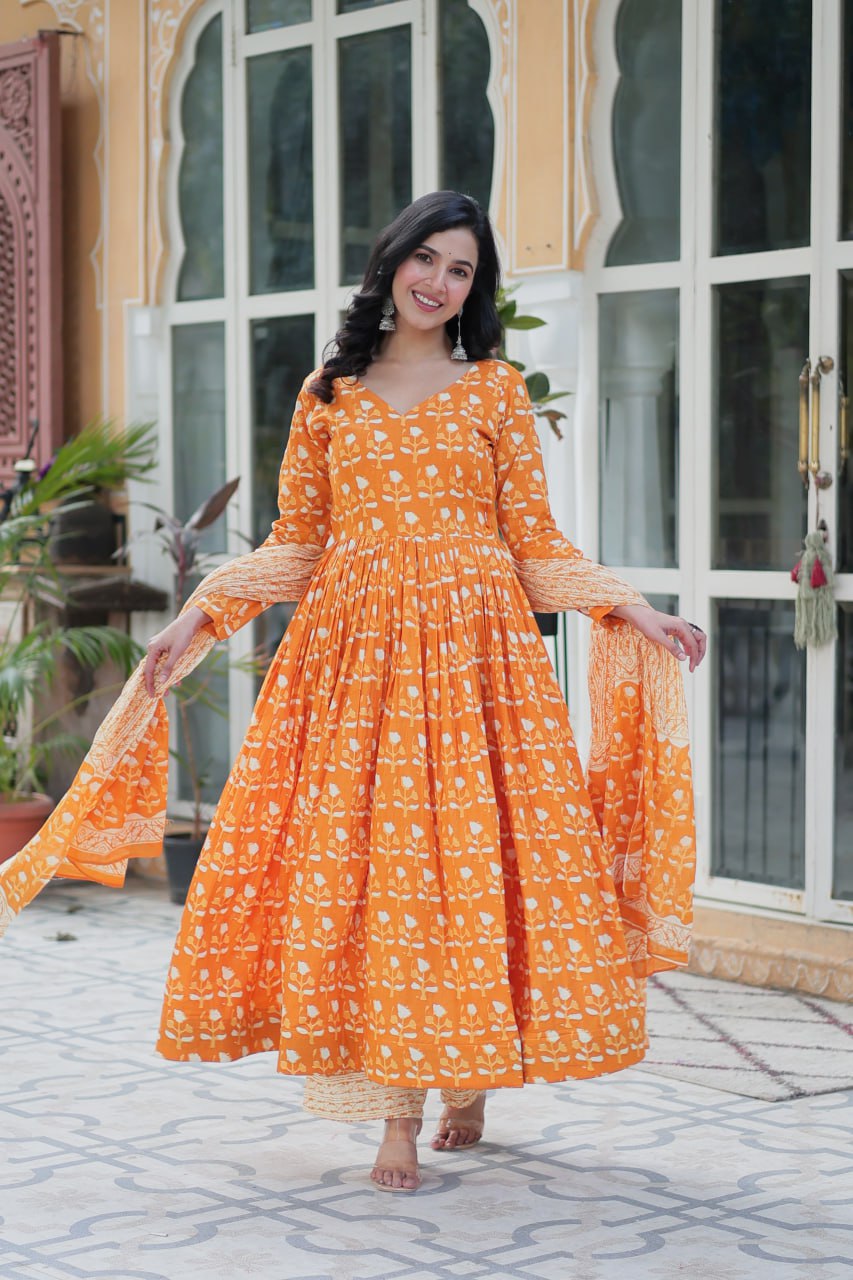 The Ridhvini Orange Pure Cotton Printed Anarkali Set is a stylish and breathable cotton Anarkali suit for women, perfect for daily wear, office wear, and festive occasions. Made from premium pure cotton, this readymade Anarkali kurta set offers comfort and elegance with a flowing silhouette, fancy V-neck, and full sleeves. Paired with straight cotton pants and a matching dupatta, this ethnic cotton suit is ideal for summer fashion. Whether you're looking for a lightweight festive outfit or a printed Anarkal