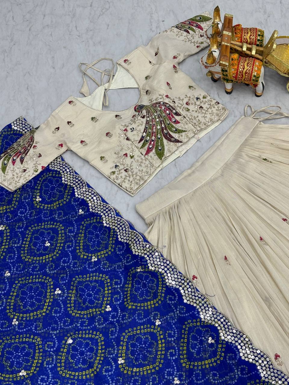 Amla off-white tissue silk lehenga choli with sequins thread work and blue Bandhej dupatta