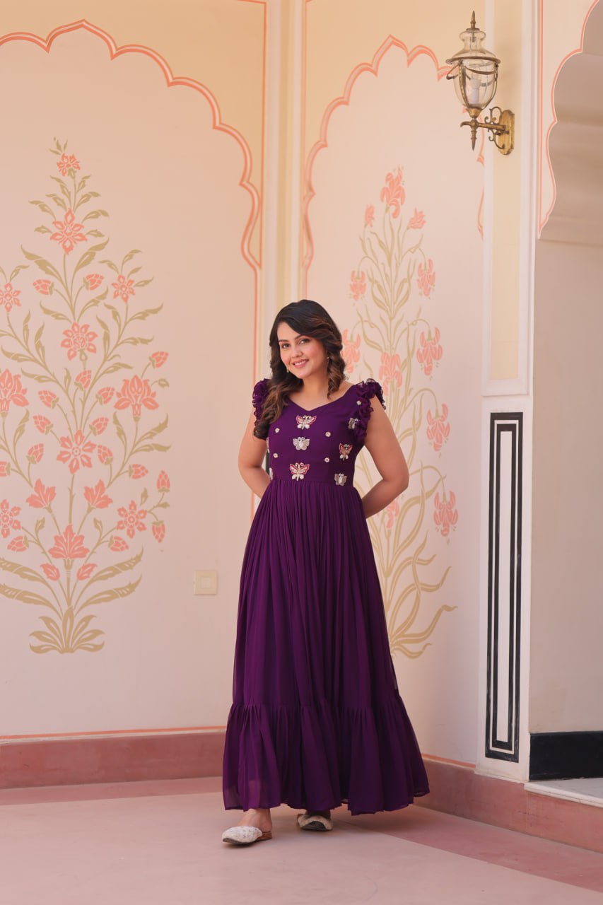 Lavi 7-meter flared designer gown in faux blooming fabric with sequin & bead embroidery, V-neck & frill shoulders – perfect for weddings & parties.