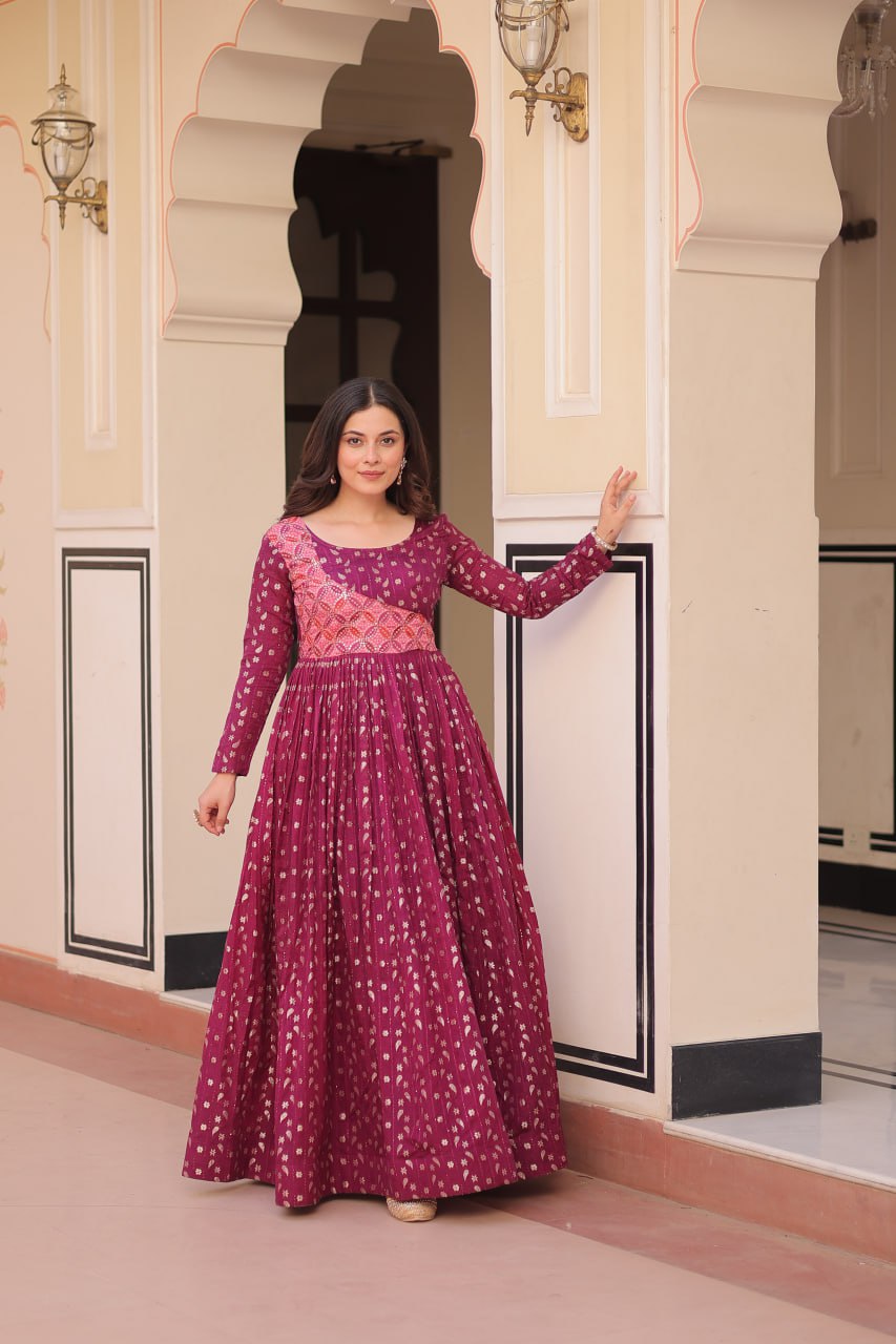 Vani Choli Printed Wine Color Gown with staple jacquard fabric, full sleeves, cotton lining, and 3-meter flare – perfect ethnic party wear gown for wedding functions, festive nights, and modern Indian women.