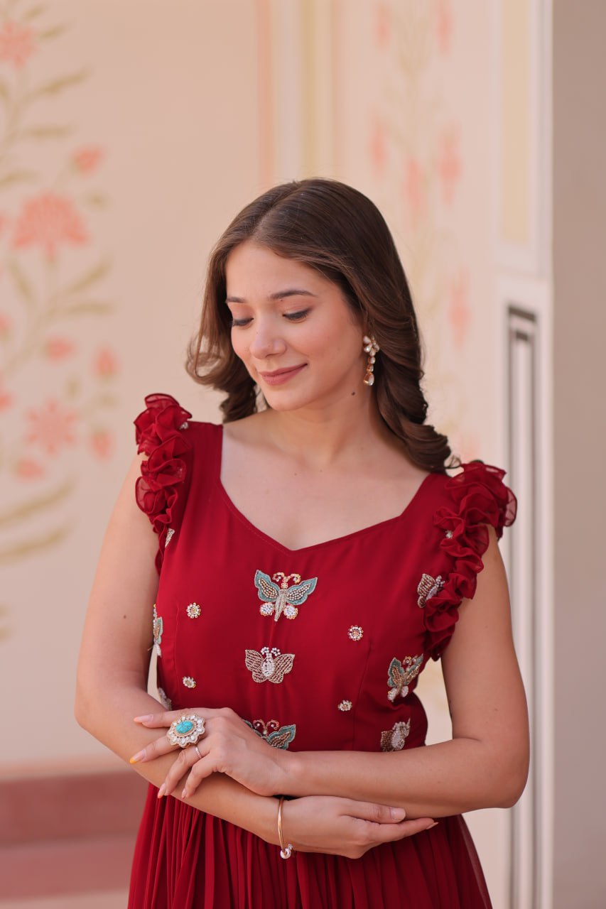 Lavi 7-meter flared designer gown in faux blooming fabric with sequin & bead embroidery, V-neck & frill shoulders – perfect for weddings & parties.