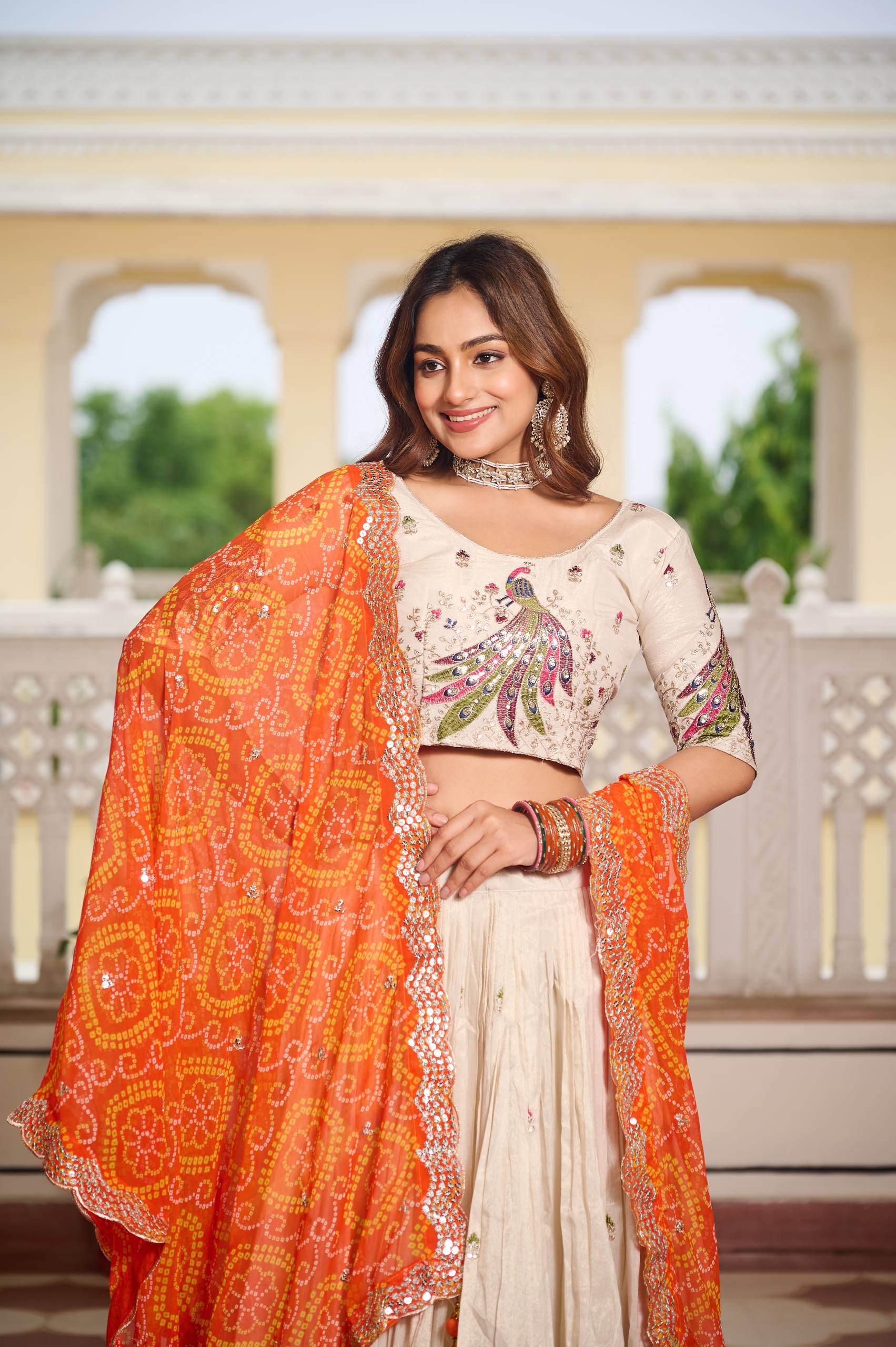 Amla off-white tissue silk lehenga choli with sequins thread work and orange Bandhej dupatta