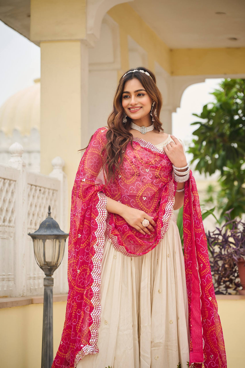 Off-white silk sequins thread embroidery lehenga choli with pink Bandhej dupatta