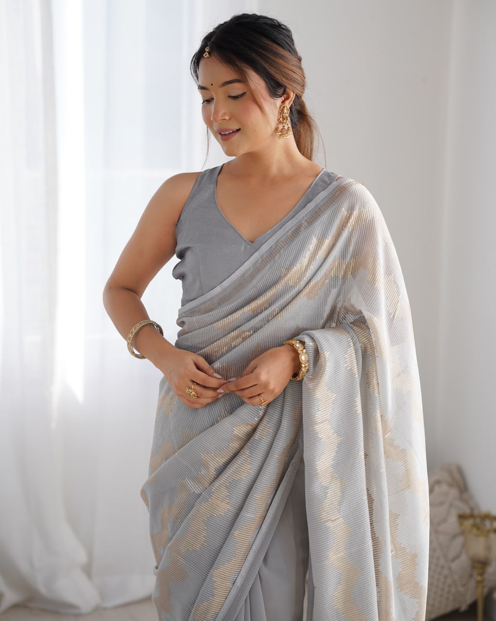 Graceful Aira Grey Georgette saree with heavy sequin embroidery and Seroski diamond embellishments, paired with an unstitched satin Banglori blouse – ideal bridal saree, festive saree, designer grey saree, elegant ethnic party wear, and luxury embroidered saree for women.