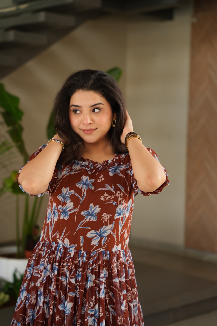 Vikarni Brown Printed Anarkali Gown in faux georgette with 12-meter flair & cotton lining – perfect for haldi, mehndi, festive & Indo-western occasions.