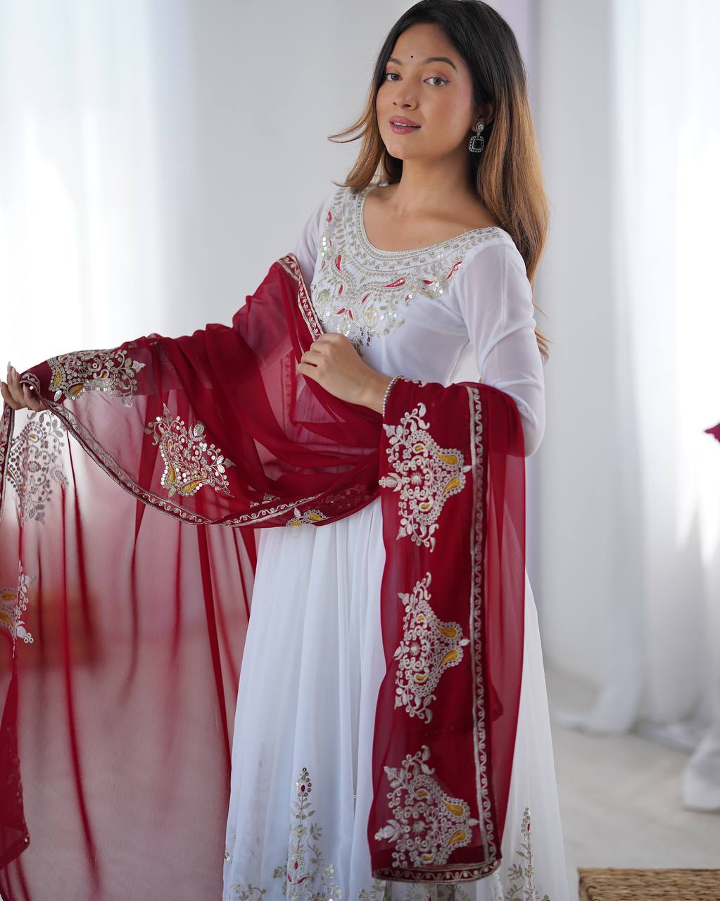 Tejvini White Embroidered Gown Set – heavy georgette gown with multi-thread 5mm sequin embroidery, full sleeves, soft cotton inner, paired with contrasting maroon embroidered dupatta and stitched bottom – ideal for weddings, receptions, and festive occasions.