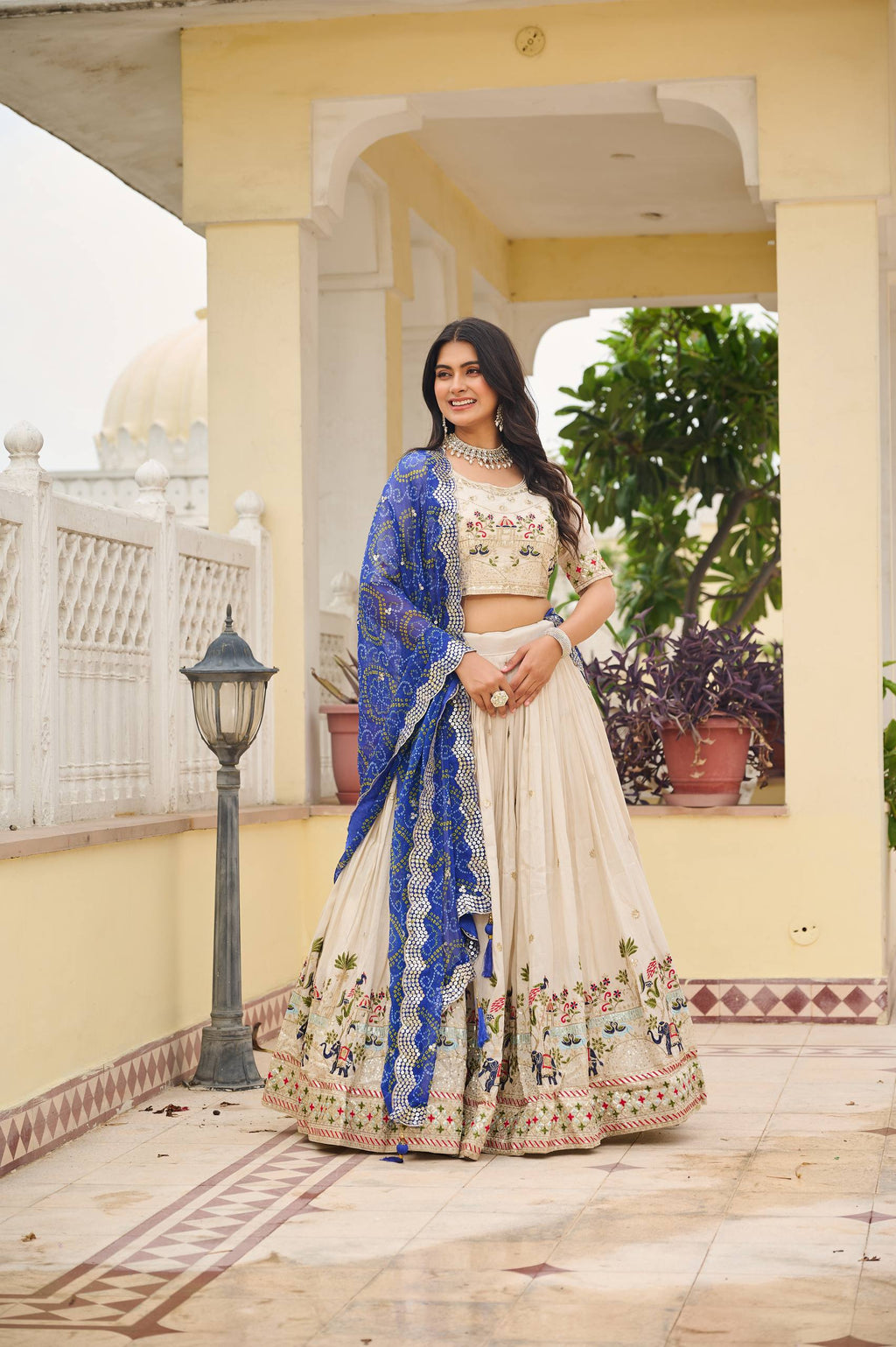 Off-white silk sequins thread embroidery lehenga choli with blue Bandhej dupatta