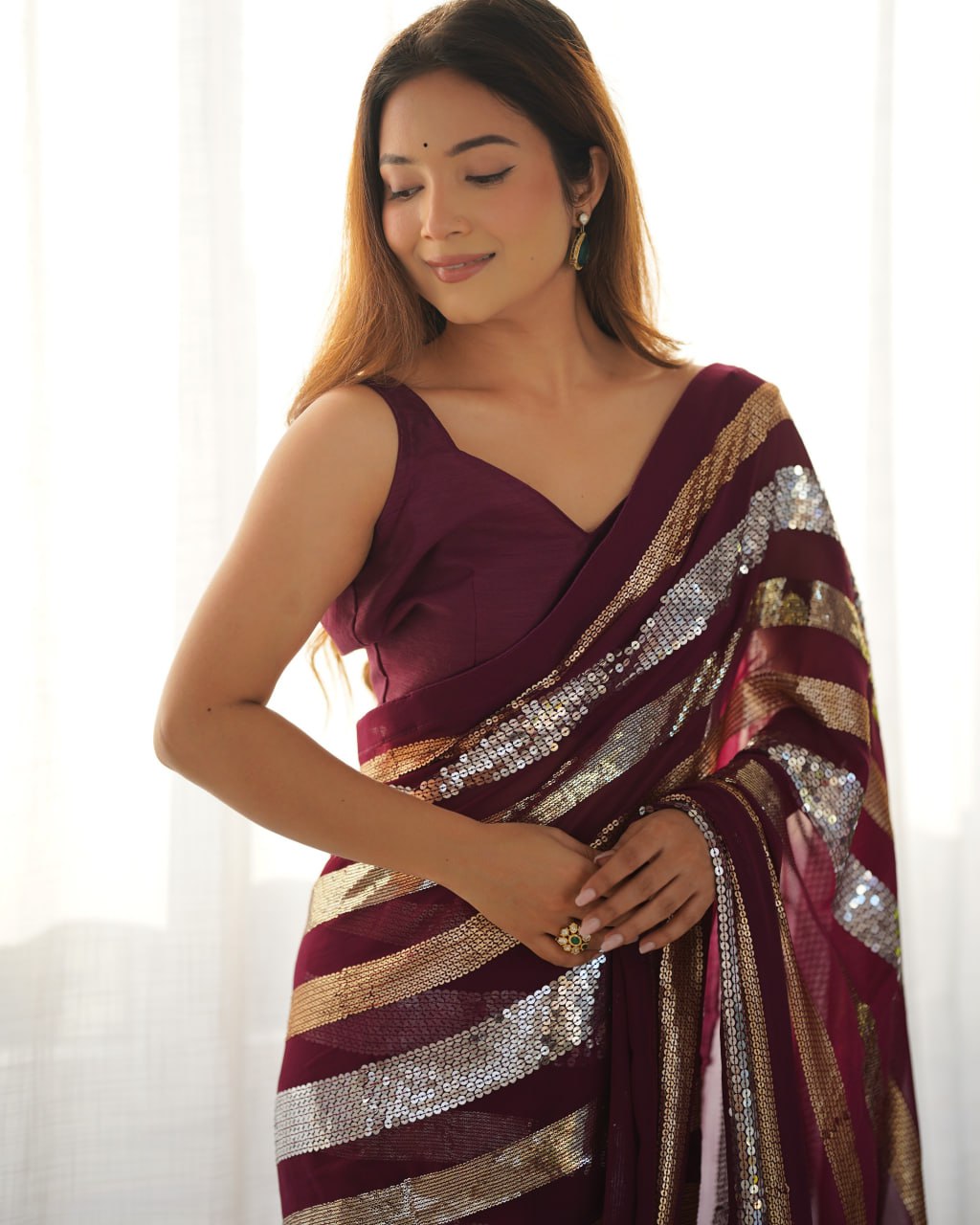 Kira Wine Georgette Saree with 3MM to 7MM sequin embroidery, elegant lining pattern and mono Banglory blouse – ideal sequin saree for wedding receptions, cocktail parties, festive wear, and premium Bollywood-style designer look.