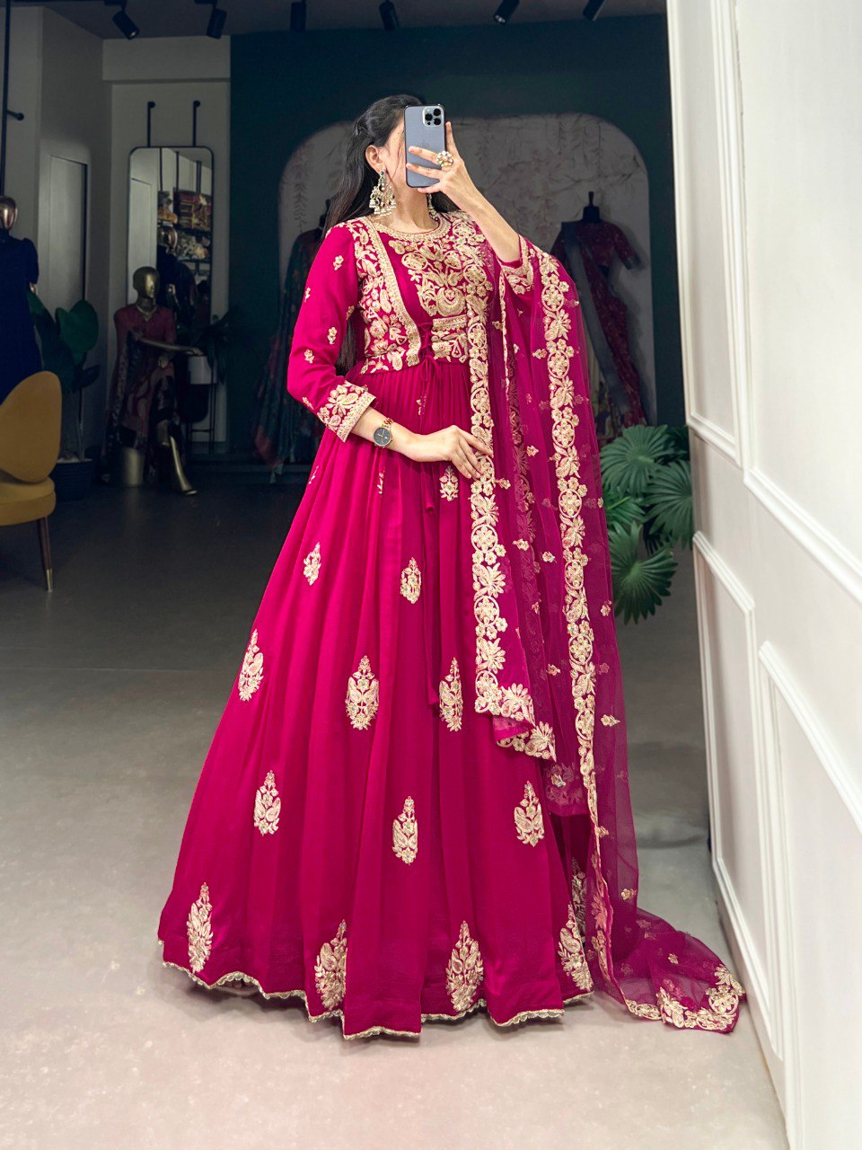 Anwitha Pink Embroidered Silk Anarkali Gown Set, crafted from luxurious Vichitra Silk with intricate sequins and thread embroidery accented by delicate lace details. This fully stitched Anarkali gown features a 3-meter flair and a soft cotton lining for comfort. Paired with a graceful net dupatta adorned with sequins embroidery and a lace border, this elegant ensemble is perfect for weddings, festive occasions, and grand celebrations