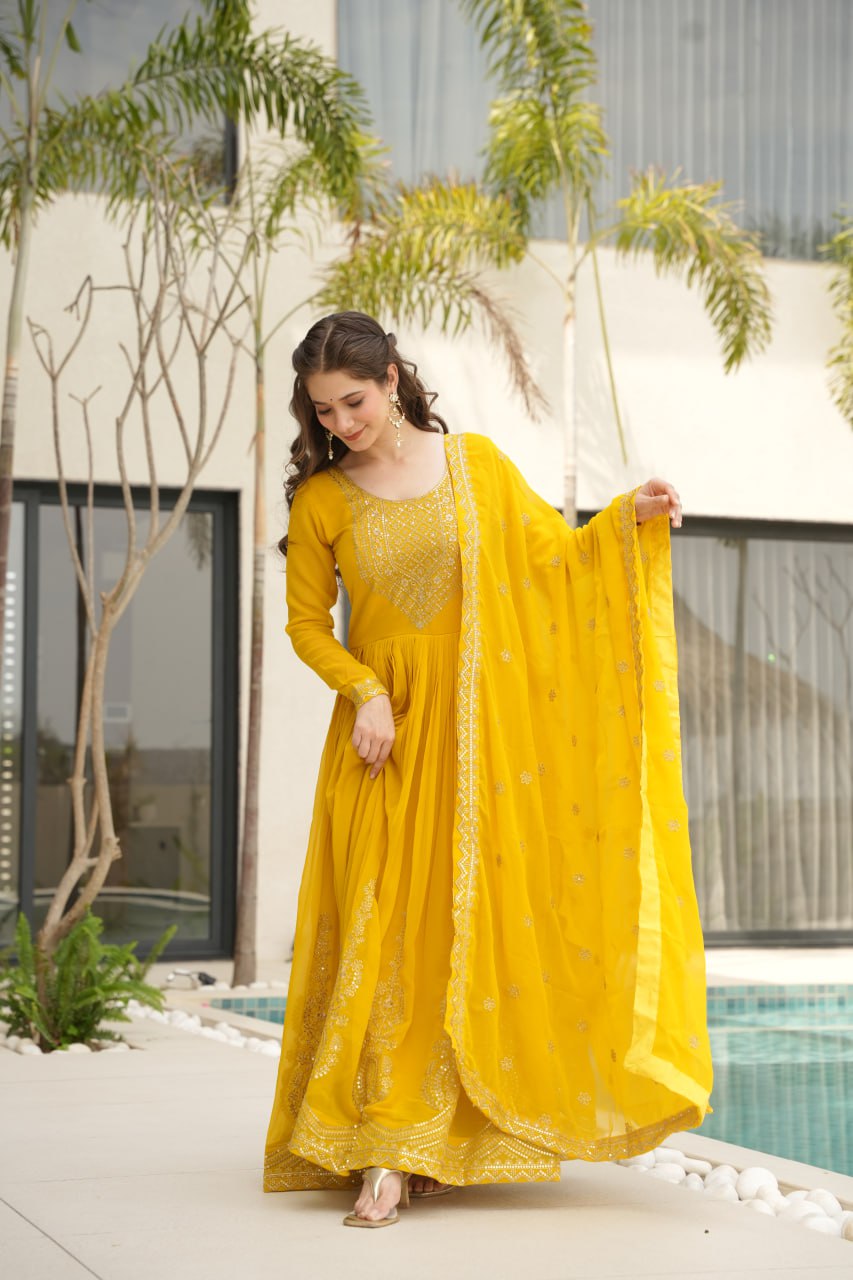 Yellow wedding gown for women with dupatta, embroidered gown design, full sleeve gown, Indian ethnic gown, stitched designer gown by Trinaari.
