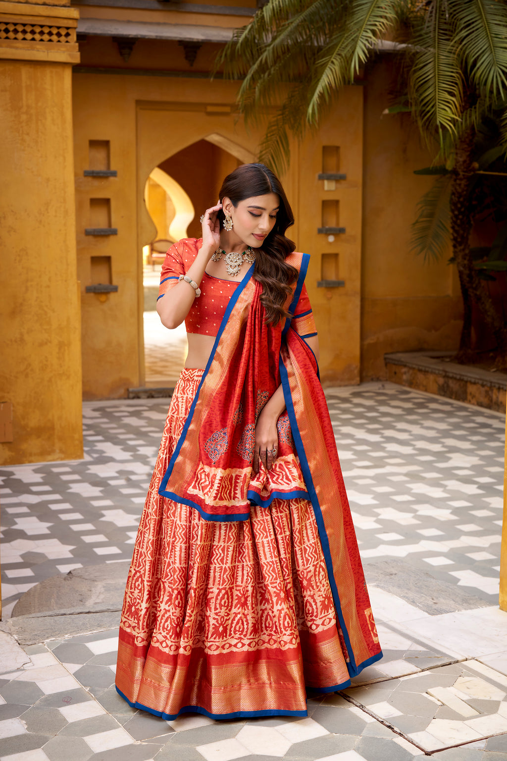 Girija rust orange Dola silk batik print lehenga choli with zari weaving work